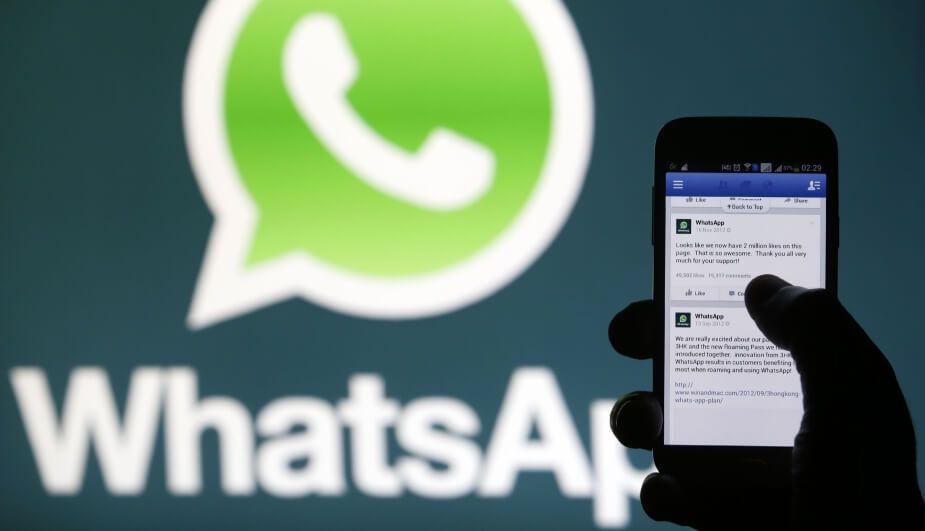 A Whatsapp App logo is seen behind a Samsung Galaxy S4 phone that is logged on to Facebook in the central Bosnian town of Zenica, February 20, 2014. Facebook Inc will buy fast-growing mobile-messaging startup WhatsApp for $19 billion in cash and stock in a landmark deal that places the world's largest social network closer to the heart of mobile communications and may bring younger users into the fold. REUTERS/Dado Ruvic (BOSNIA AND HERZEGOVINA - Tags: BUSINESS)